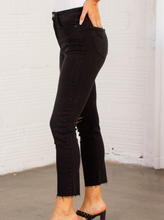 Load image into Gallery viewer, These slim straight black jeans from Just Black offer up an edgy, cool, and casual vibe that is perfect for the fall & winter. Simple sleek, we love how they pull together any look and even with the distressed knee slit add a slightly dressier and elevated look to your outfit. 93% Cotton, 5% Polyester, 2% Spandex Machine wash cold, Do not bleach, Tumble dry low, Dry cleaning possible