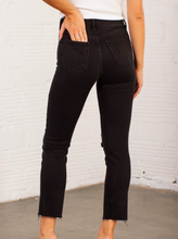 Load image into Gallery viewer, These slim straight black jeans from Just Black offer up an edgy, cool, and casual vibe that is perfect for the fall & winter. Simple sleek, we love how they pull together any look and even with the distressed knee slit add a slightly dressier and elevated look to your outfit. 93% Cotton, 5% Polyester, 2% Spandex Machine wash cold, Do not bleach, Tumble dry low, Dry cleaning possible