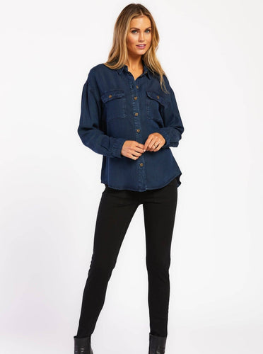 Meet your everyday layer—this utility style shirt is equally cozy and stylish. This long sleeve collar shirt is finished with tencel, button details, and front flap pockets.  100% Eco-Friendly Tencel Machine wash cold, tumble dry low Color: Overdye Indigo Model is 5'9