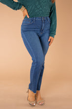 Load image into Gallery viewer, In a classic straight-leg silhouette, these high-rise jeans are perfect for showcasing your best assets. Dress them up or down for any weekday or weekend. These jeans have no distressing, a great wash, and scissor cut bottom hems.   Chelsey is wearing a size 25 in the light denim Justice is wearing a size 29 n the dark denim Runs true to size  93% Cotton 5% Polyester 2% Spandex Wash Instructions   Hand wash cold separately. Do not bleach. Hang to dry.
