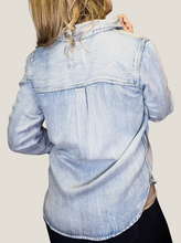 Load image into Gallery viewer, Color: Light Sandblast (Light wash) Fabric: 100% Tencel Care: Machine wash, Tumble dry low Fit: True to size Details: Soft chambray fabric, button front, button cuff, chest pockets, collar, scrape distress detail, back pleat
