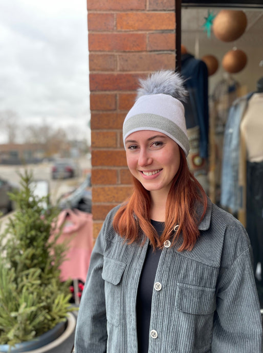 Super cute white beanie with a grey sparkly stripe and a pom pom