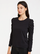 Load image into Gallery viewer, Update your closet with this elevated essential. Ruched details create gentle pleats on the side shoulders of a fitted top. Crafted in organic cotton jersey with a banded neck, 3/4 sleeves, and straight hem. Tuck into a coated skinny for a chic, modern look.
