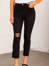 Load image into Gallery viewer, These slim straight black jeans from Just Black offer up an edgy, cool, and casual vibe that is perfect for the fall &amp; winter. Simple sleek, we love how they pull together any look and even with the distressed knee slit add a slightly dressier and elevated look to your outfit.  93% Cotton, 5% Polyester, 2% Spandex   Machine wash cold, Do not bleach, Tumble dry low, Dry cleaning possible 
