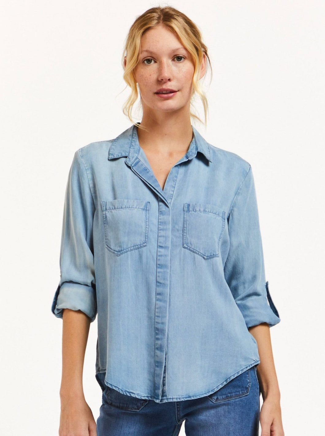 The Riley collared button down shirt features rolled tab sleeves, double chest pockets, a split back tail, and a frayed hem. This shirt is a perfect staple to any wardrobe.   100% Eco Friendly Tencel™ Machine wash cold Color: Fade Out Blue Model is 5'9